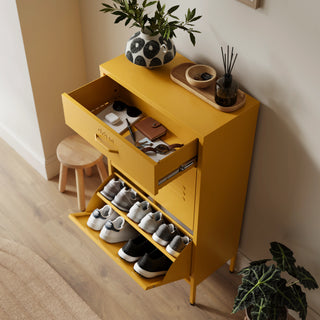 The Shoreditch shoe cabinet in mustard with a top drawer, two lower shoe compartments and matching handles, styled in a hallway.