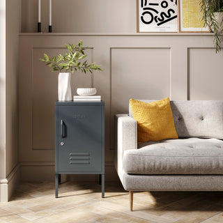 The Camden slate grey metal storage locker as a side table next to a sofa