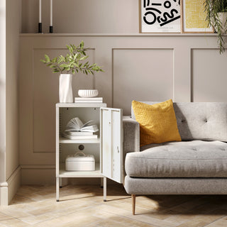 The Camden vanilla metal storage locker open as a side table next to a sofa