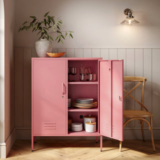 The Fulham metal storage locker in flamingo pink with 2 doors, one open showing tableware inside 