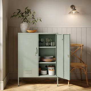 The Fulham metal storage locker in sage green with 2 doors, one open showing tableware inside 