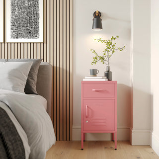 Metal side table locker in forest green with one drawer and one door, in a room next to a bed