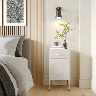 Metal side table locker in vanilla with one drawer and one door, in a room next to a bed