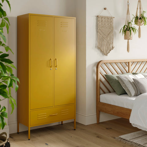 Metal, tall, double-door and single-drawer storage locker in mustard yellow, in a bedroom