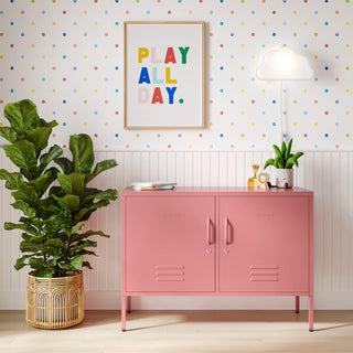 The Oxford metal storage locker in flamingo pink with two doors, with books and toys on top