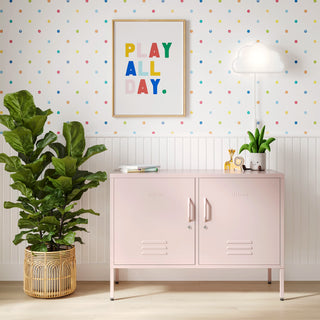 The Oxford metal storage locker in light pink with two doors, with books and toys on top