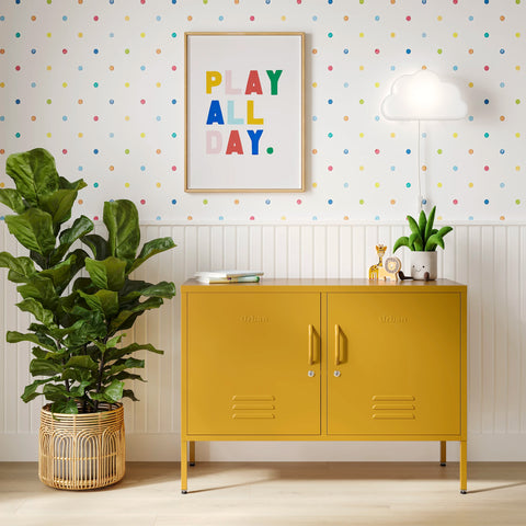 The Oxford metal storage locker in mustard yellow with two doors, with books and toys on top