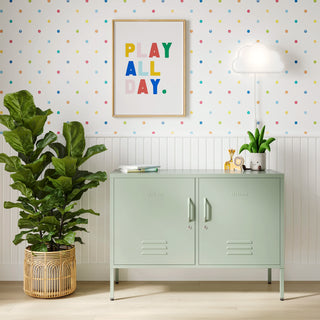 The Oxford metal storage locker in sage green with two doors, with books and toys on top