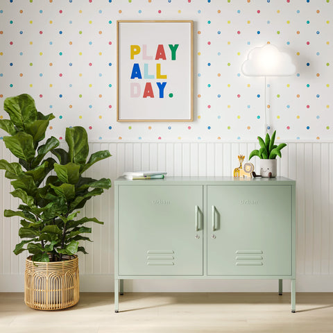 The Oxford metal storage locker in sage green with two doors, with books and toys on top