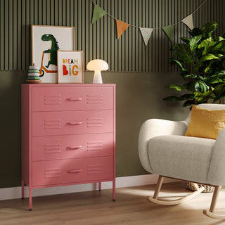 The Harrow flamingo pink metal drawers with 4 drawers, in a room next to a chair