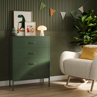 The Harrow forest green metal drawers with 4 drawers, in a room next to a chair