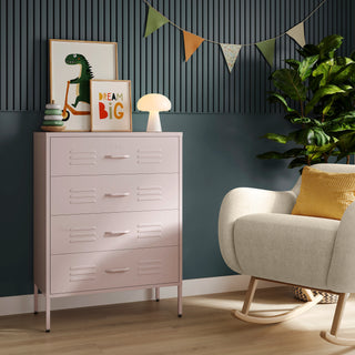 The Harrow light pink metal drawers with 4 drawers, in a room next to a chair