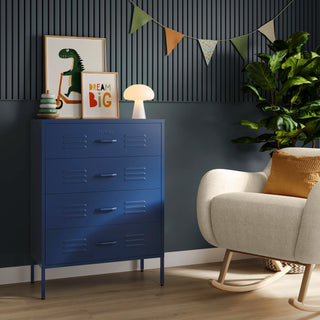 The Harrow navy blue metal drawers with 4 drawers, in a room next to a chair