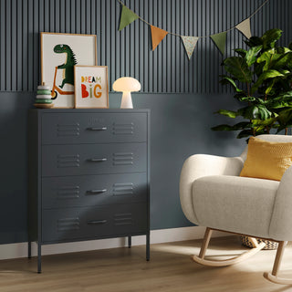 The Harrow slate grey metal drawers with 4 drawers, in a room next to a chair