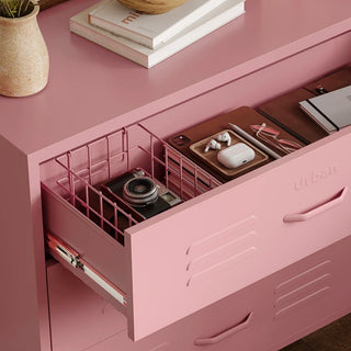 The Lambeth metal storage drawers in flamingo pink, with one draw open showing a basket and books 