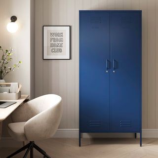 The Chelsea tall double-door metal storage locker in navy blue in a room