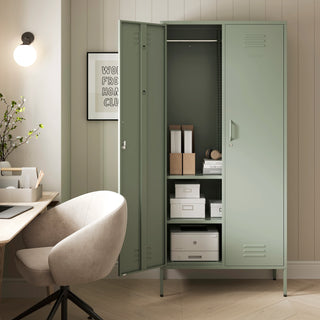 The Chelsea tall double-door metal storage locker in sage green with one door open, in a room